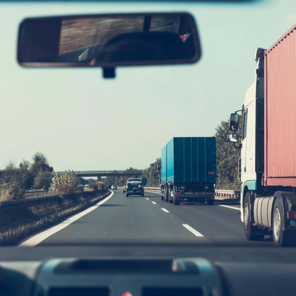 View through rearview mirror of trucks on a German highway, driving towards Bamberg.